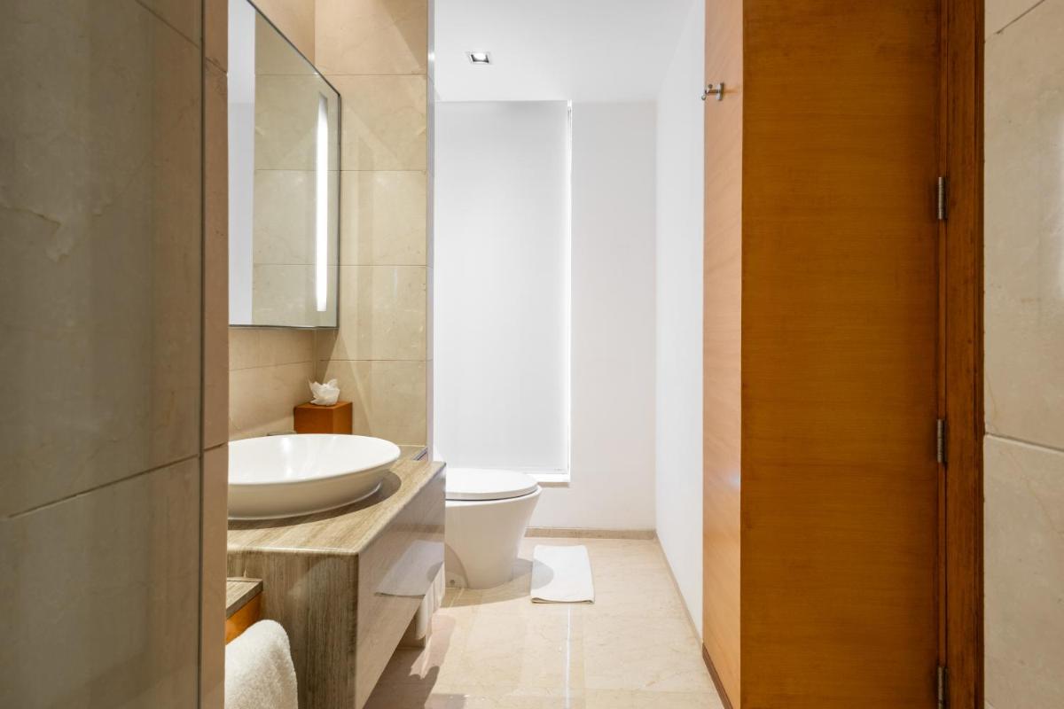 a bathroom with a sink and a toilet at Hyatt Pune in Pune