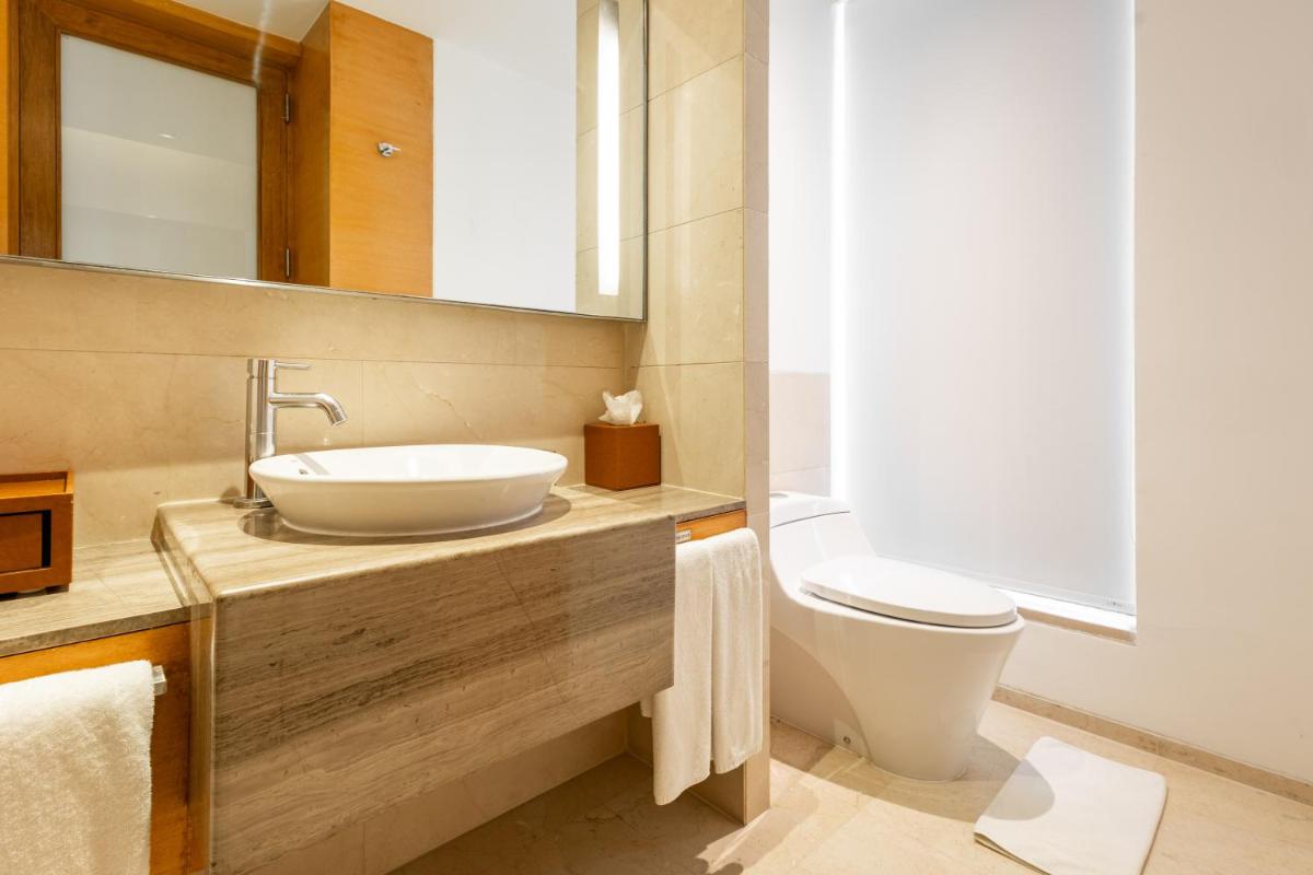 a bathroom with a sink and a toilet at Hyatt Pune in Pune