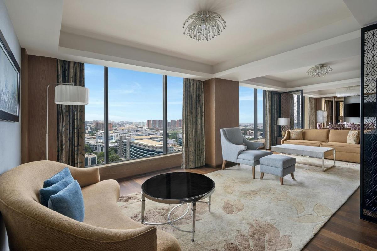 a living room with a view of a city at Bengaluru Marriott Hotel Whitefield in Bengaluru