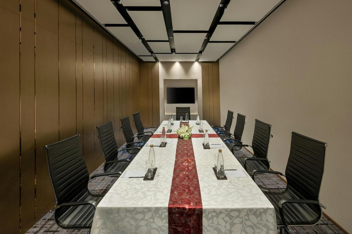 a conference room with a long table and chairs at Bengaluru Marriott Hotel Whitefield in Bengaluru