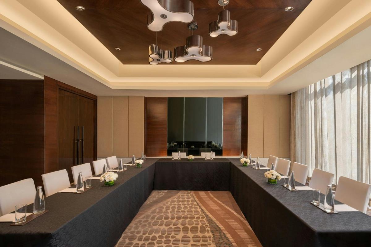 a large conference room with a long table and chairs at Bengaluru Marriott Hotel Whitefield in Bengaluru