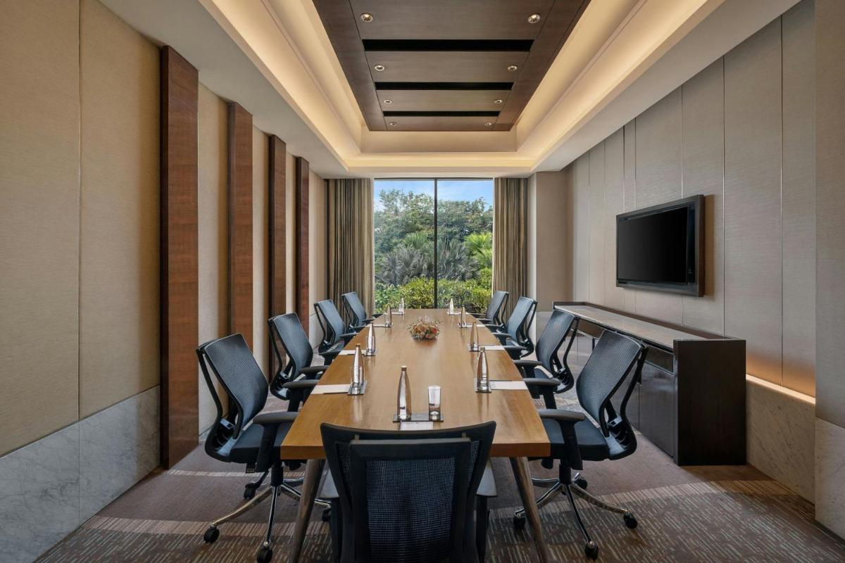 a conference room with a long table and chairs at Bengaluru Marriott Hotel Whitefield in Bengaluru