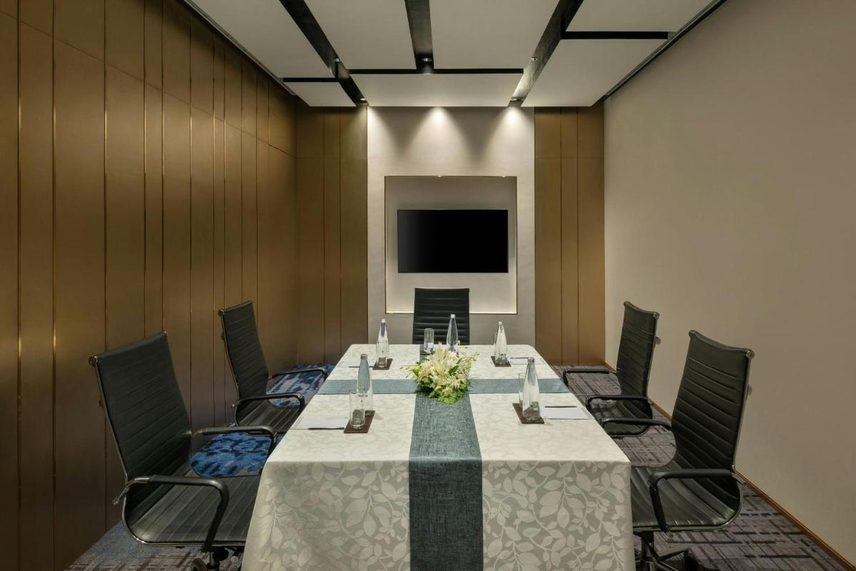 a conference room with a long table and chairs at Bengaluru Marriott Hotel Whitefield in Bengaluru