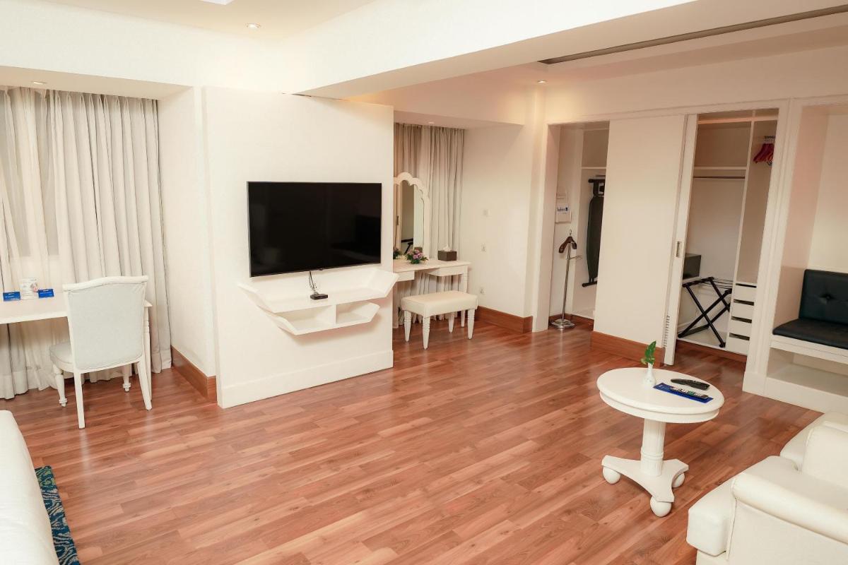 a living room with a large flat screen tv at Radisson Blu Kochi in Cochin