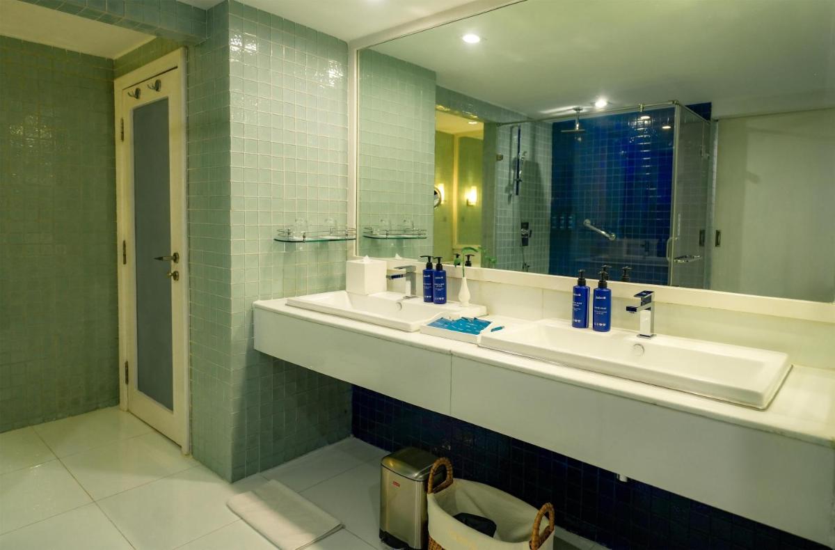a bathroom with two sinks and a mirror at Radisson Blu Kochi in Cochin
