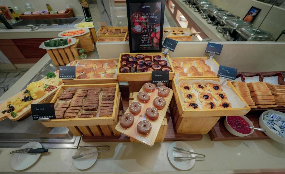 a display of different types of pastries in a bakery at Radisson Blu Kochi in Cochin