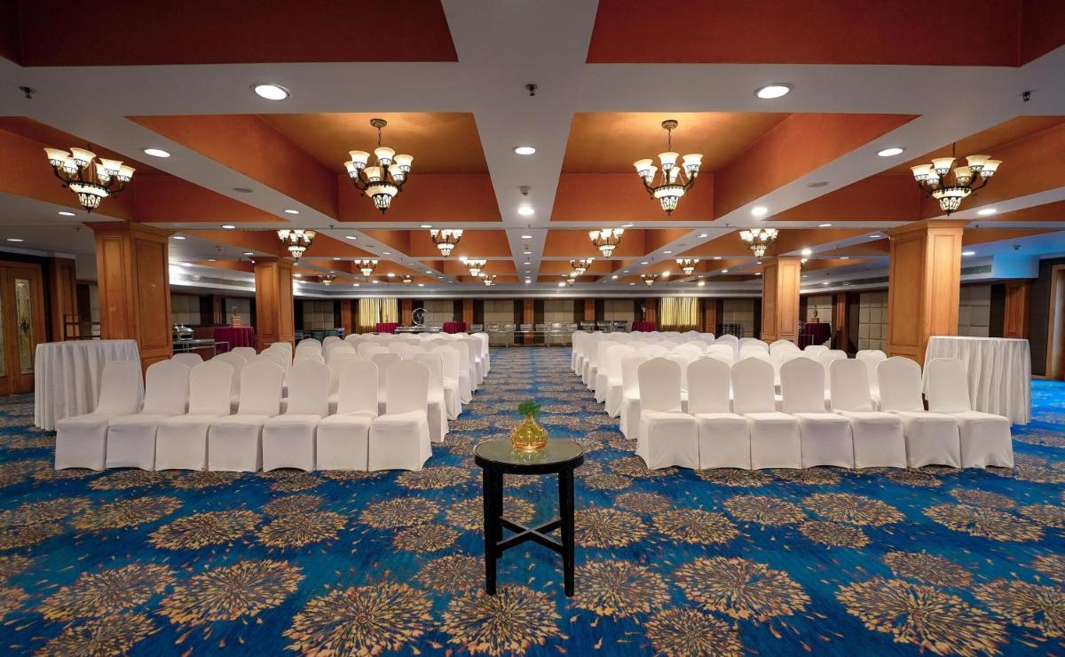 a row of white chairs in a banquet hall at Radisson Blu Kochi in Cochin