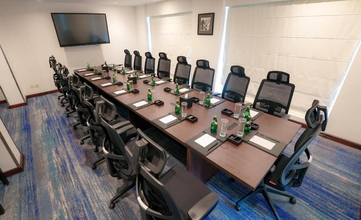 a conference room with a long table and chairs at Radisson Blu Kochi in Cochin