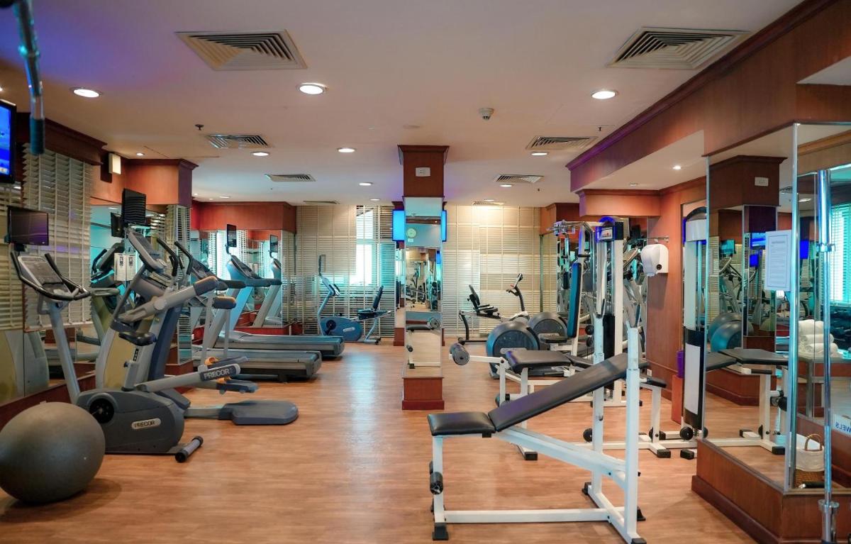 a gym with a lot of treadms and machines at Radisson Blu Kochi in Cochin