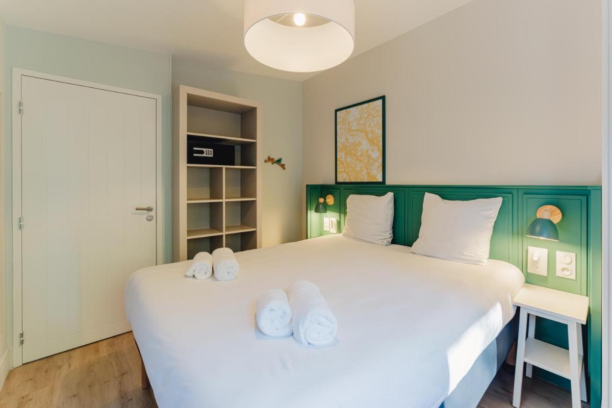 Cama o camas de una habitación en Center Parcs Villages Nature Paris