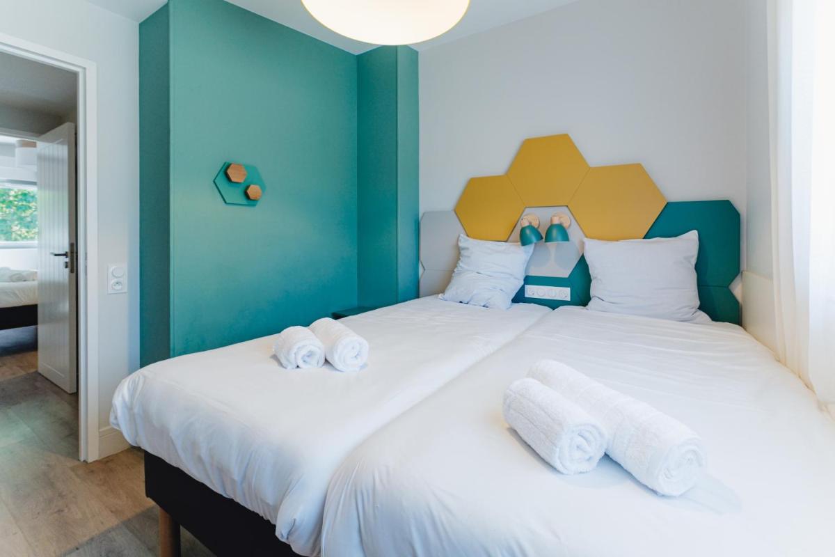 Cama o camas de una habitación en Center Parcs Villages Nature Paris