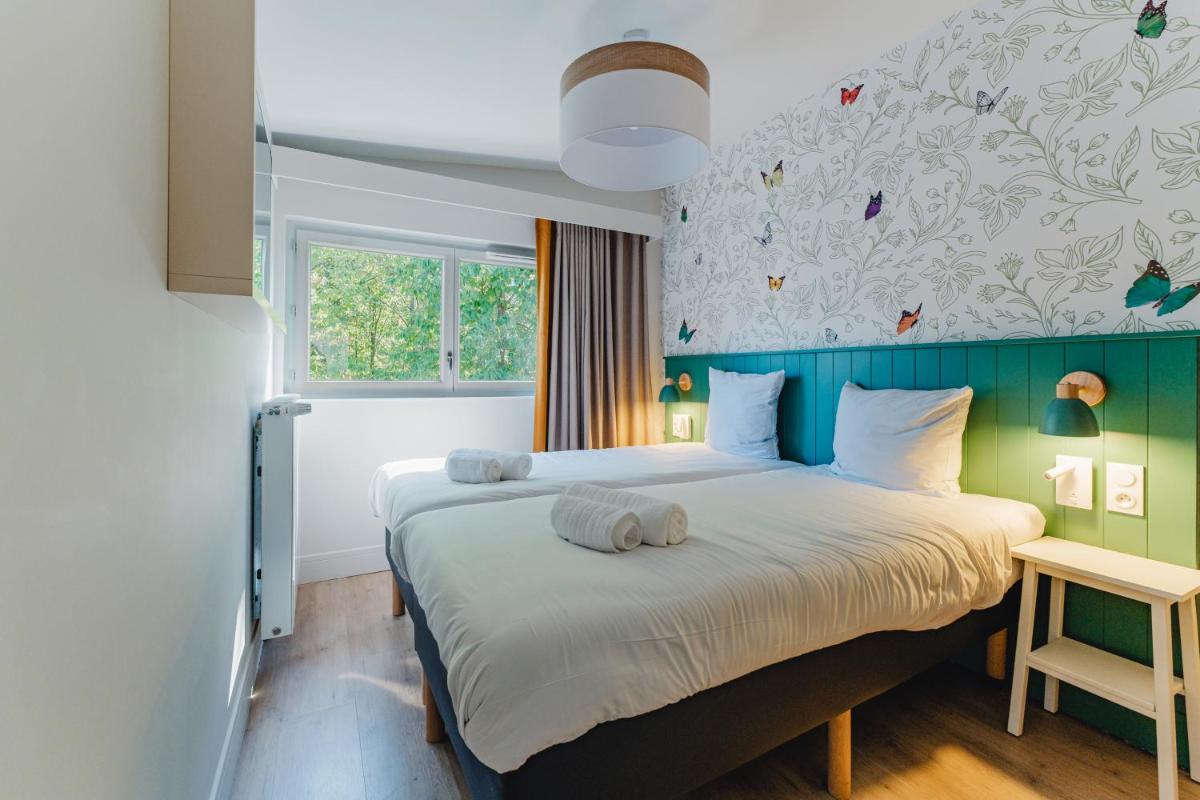 Cama o camas de una habitación en Center Parcs Villages Nature Paris