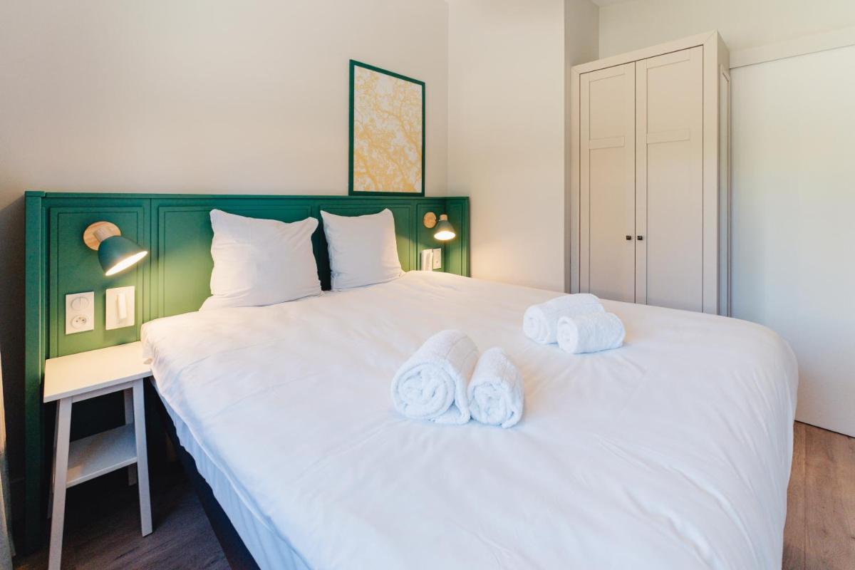 Cama o camas de una habitación en Center Parcs Villages Nature Paris