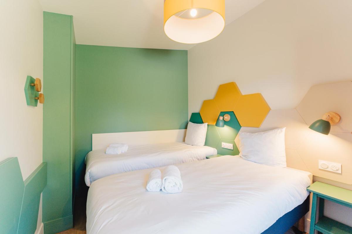 Cama o camas de una habitación en Center Parcs Villages Nature Paris