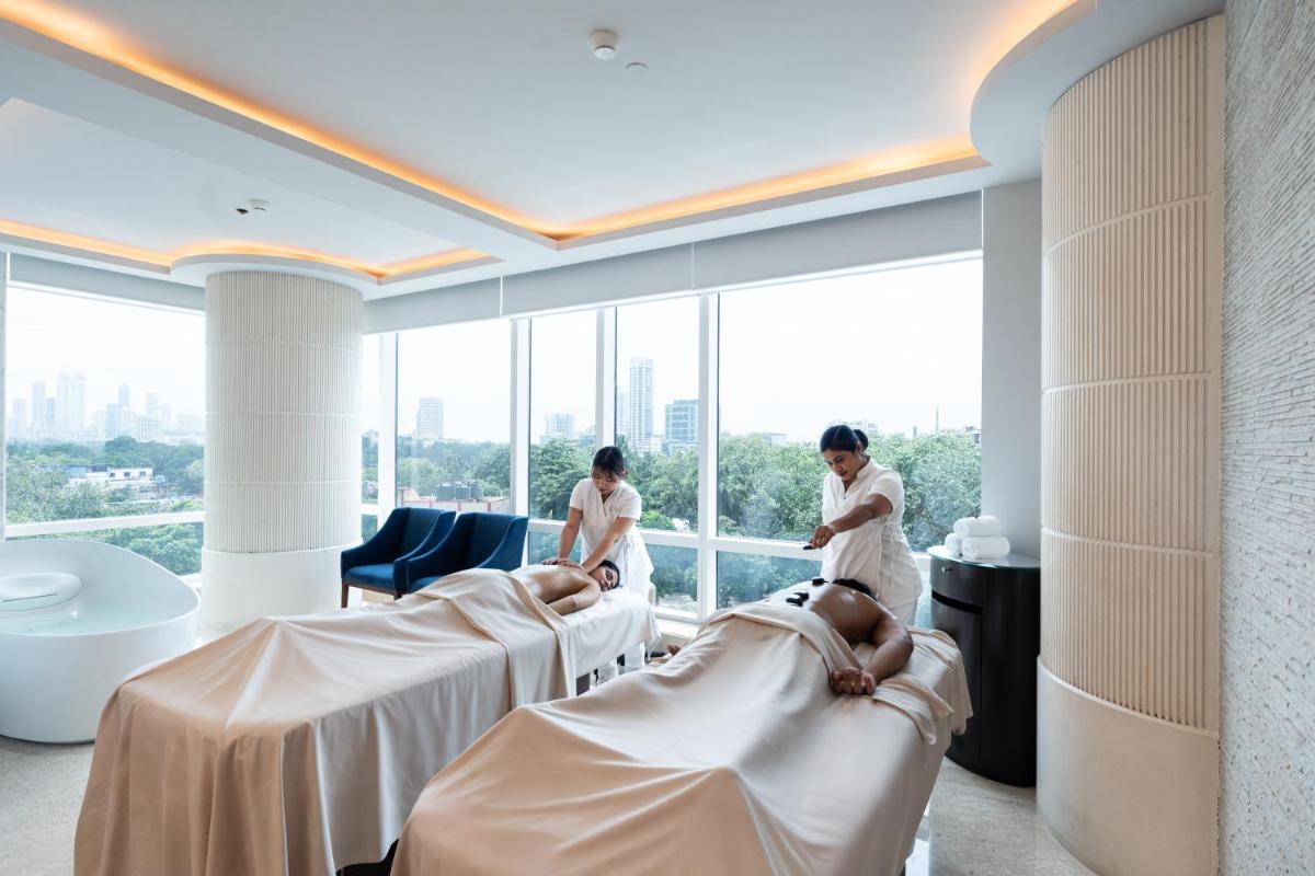 two women standing in a hospital room with beds at Four Seasons Hotel Mumbai in Mumbai