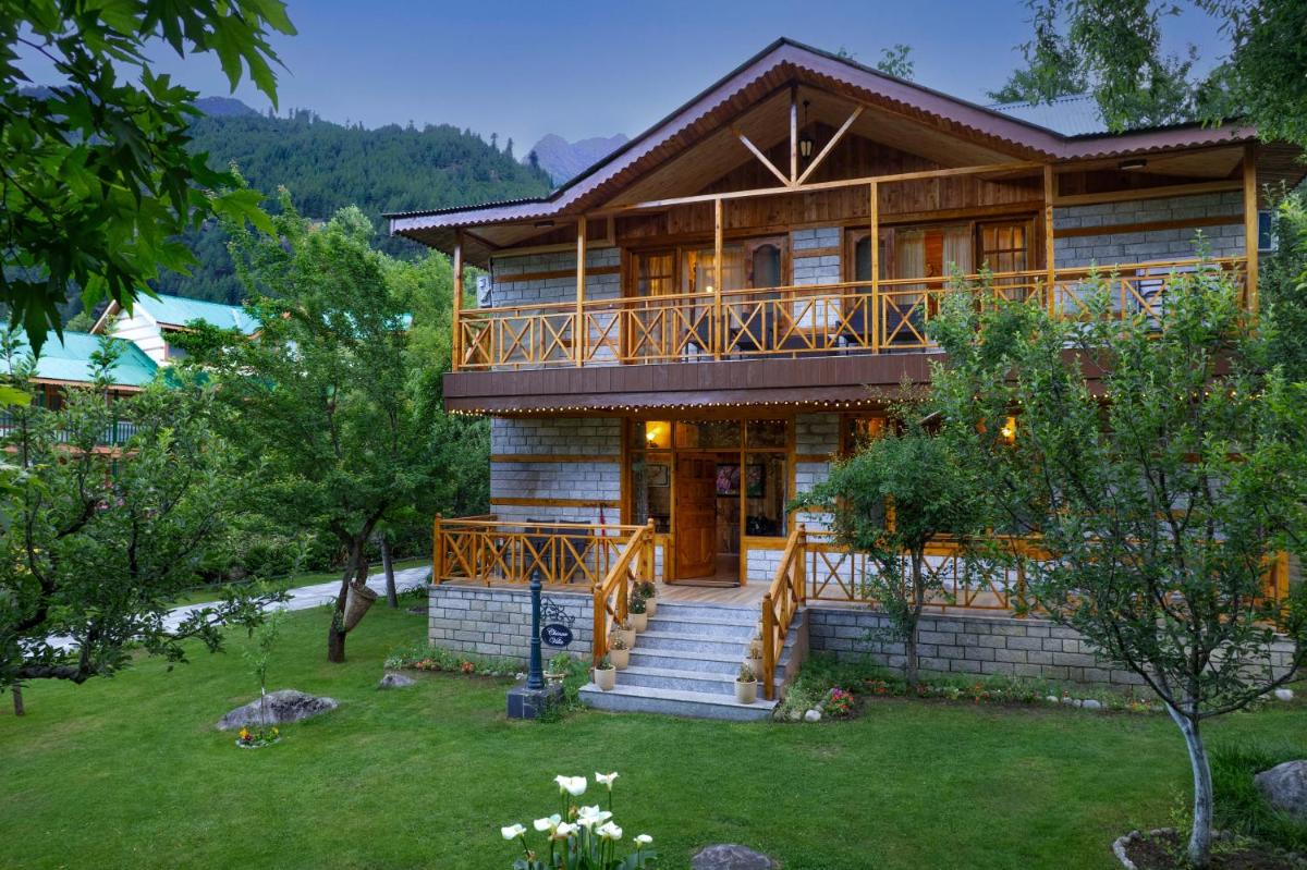 a large wooden house with a porch and a deck at Storii By ITC Hotels Urvashis Retreat, Manali in Manāli