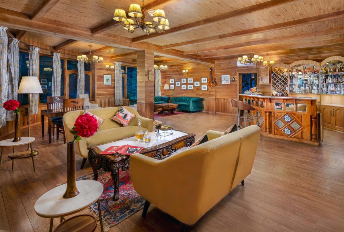 a living room with a couch and a table and chairs at Storii By ITC Hotels Urvashis Retreat, Manali in Manāli