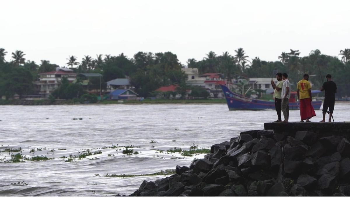 a group of people standing on the edge of a body of water at Radisson Blu Kochi in Cochin