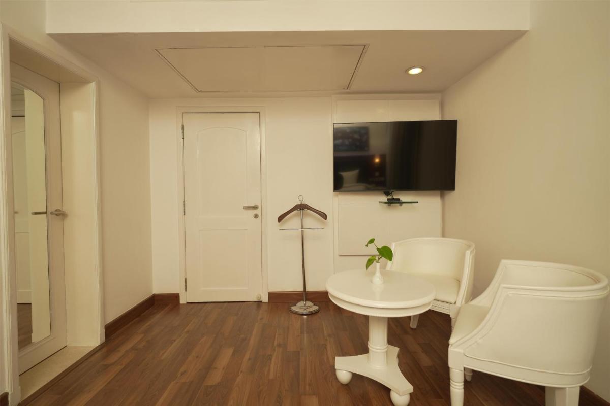 a room with a table and two chairs and a door at Radisson Blu Kochi in Cochin