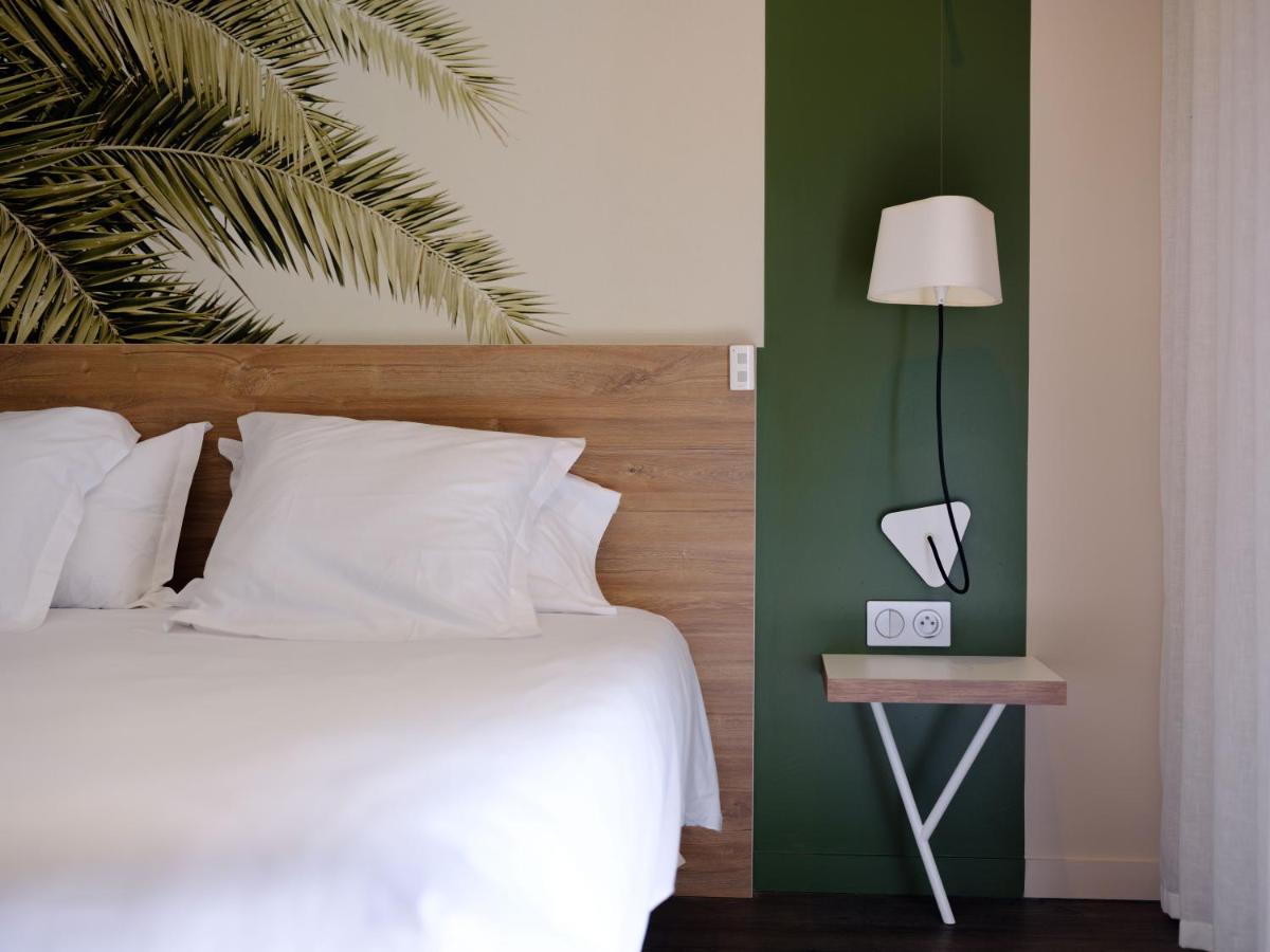 Un ou plusieurs lits dans un hébergement de l'établissement Logis Hôtel Domaine du Moulin Cavier - Restaurants & Spa