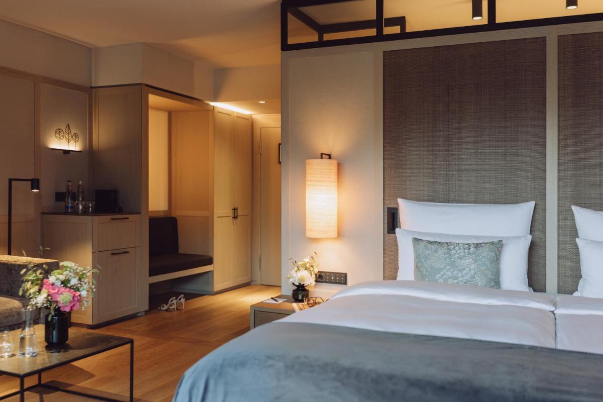 Ein Bett oder Betten in einem Zimmer der Unterkunft Parkhotel Egerner Höfe