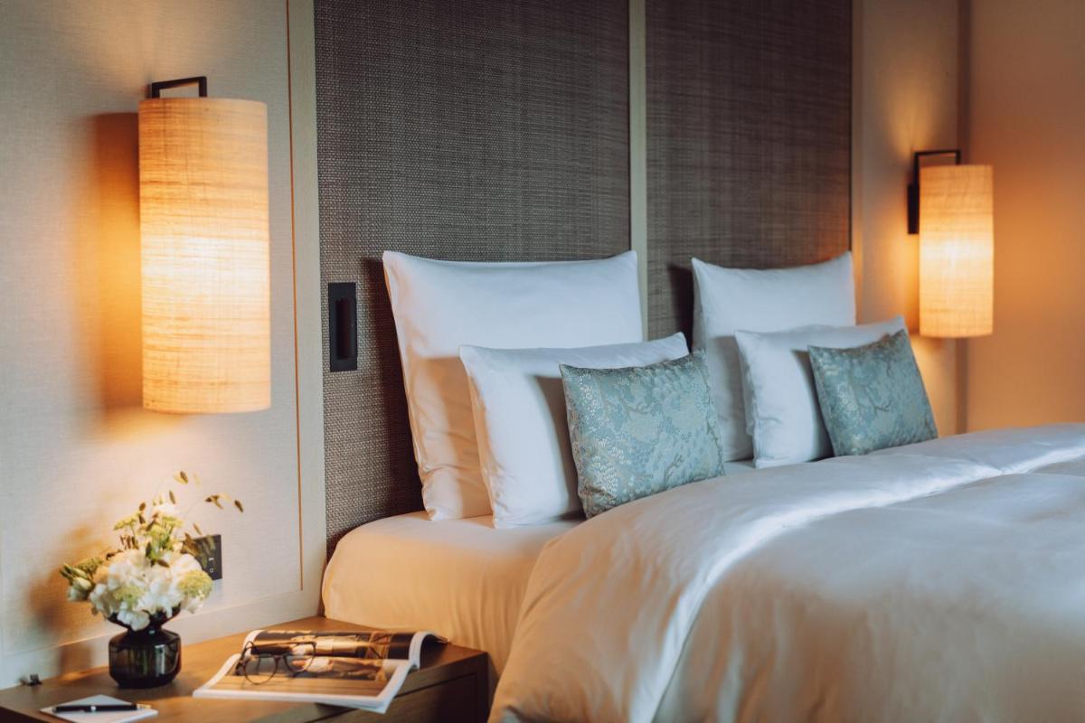 Ein Bett oder Betten in einem Zimmer der Unterkunft Parkhotel Egerner Höfe