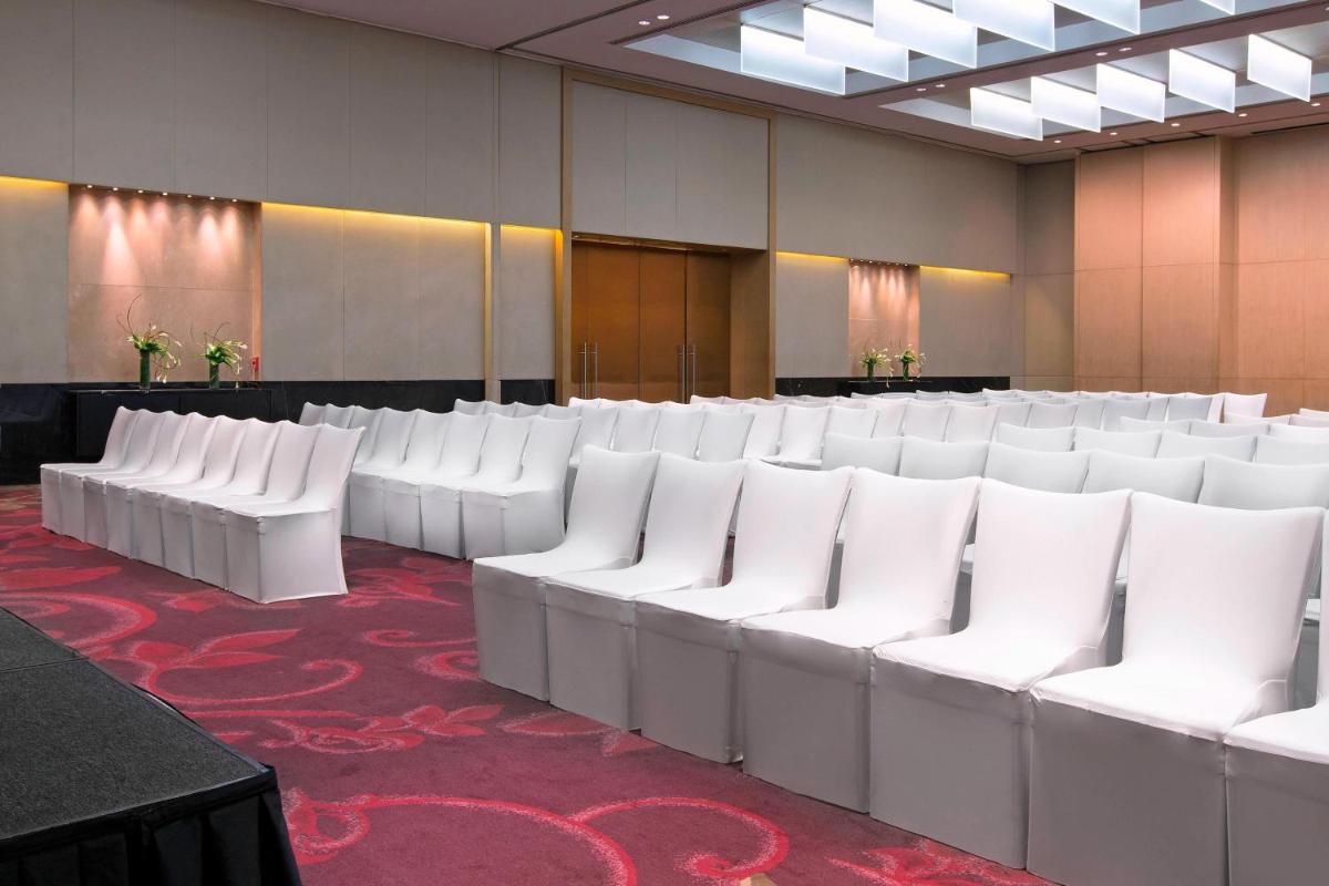 a row of white chairs in a room at The Westin Mumbai Garden City in Mumbai
