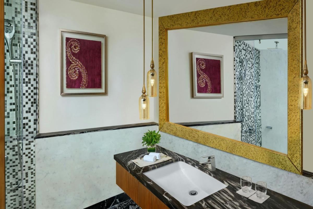 a bathroom with a sink and a mirror at ITC Kakatiya, a Luxury Collection Hotel, Hyderabad in Hyderabad