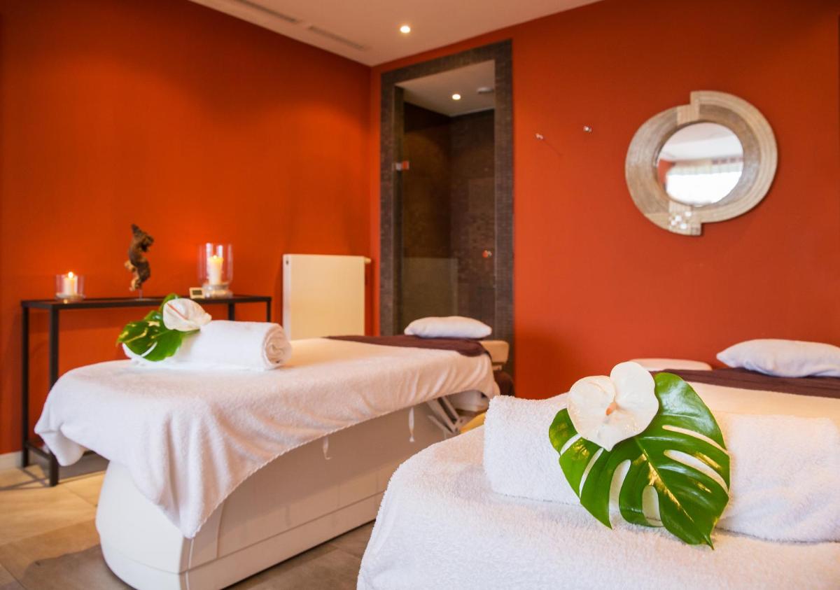 Ein Bett oder Betten in einem Zimmer der Unterkunft Strandhotel Dünenmeer - Adults only