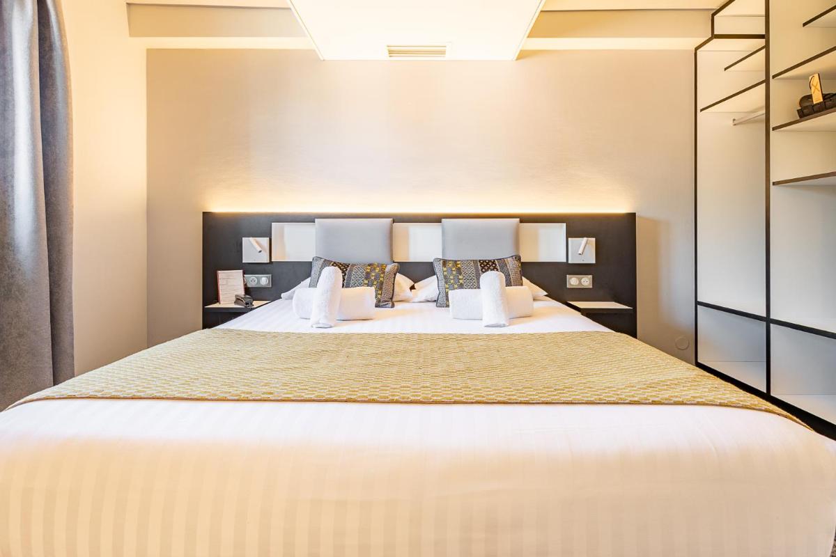 Un ou plusieurs lits dans un hébergement de l'établissement Brit Hotel, Spa & Restaurant - Colmar Est