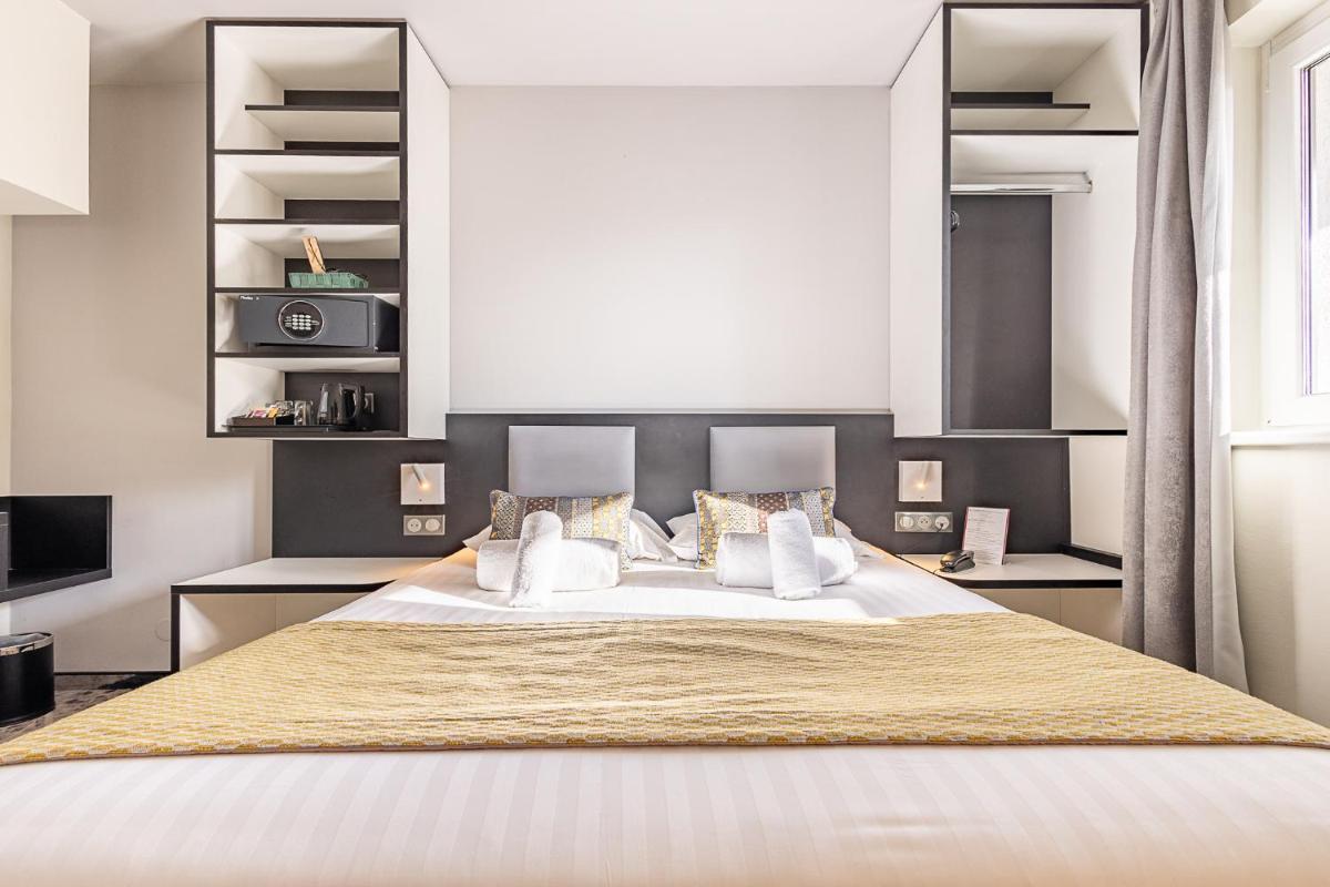 Un ou plusieurs lits dans un hébergement de l'établissement Brit Hotel, Spa & Restaurant - Colmar Est