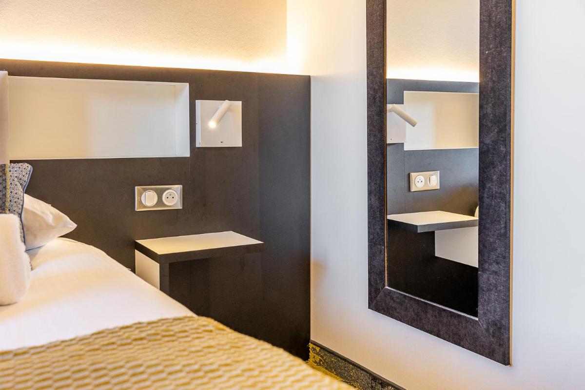 Un ou plusieurs lits dans un hébergement de l'établissement Brit Hotel, Spa & Restaurant - Colmar Est