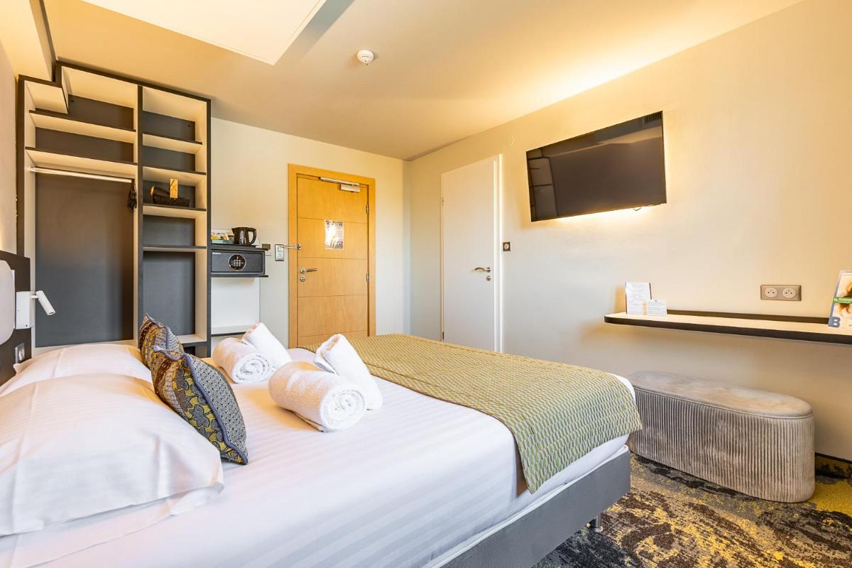 Un ou plusieurs lits dans un hébergement de l'établissement Brit Hotel, Spa & Restaurant - Colmar Est