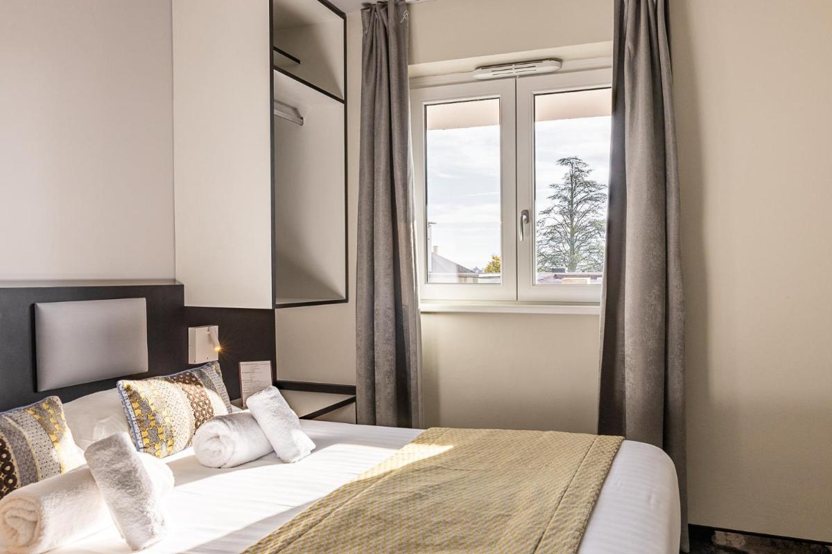 Un ou plusieurs lits dans un hébergement de l'établissement Brit Hotel, Spa & Restaurant - Colmar Est