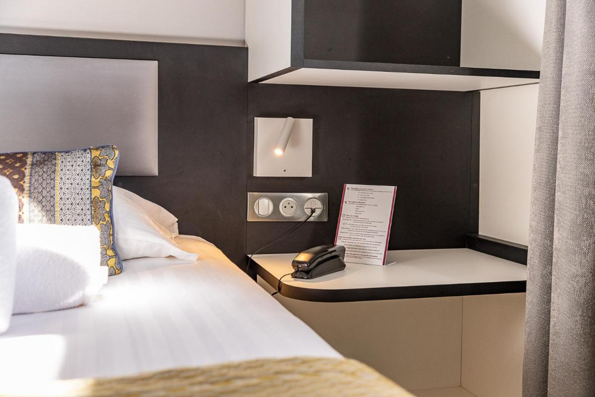 Un ou plusieurs lits dans un hébergement de l'établissement Brit Hotel, Spa & Restaurant - Colmar Est