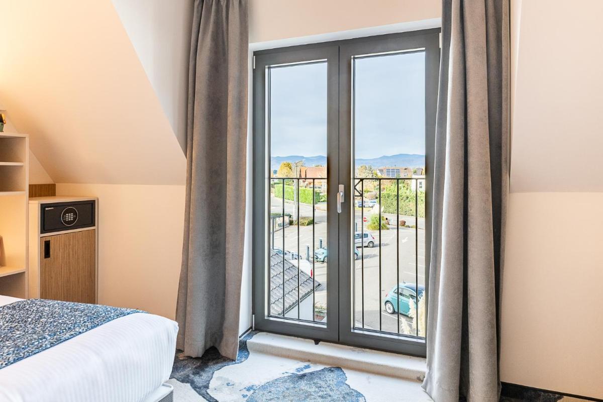 Un ou plusieurs lits dans un hébergement de l'établissement Brit Hotel, Spa & Restaurant - Colmar Est