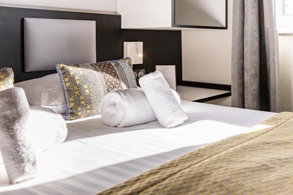 Un ou plusieurs lits dans un hébergement de l'établissement Brit Hotel, Spa & Restaurant - Colmar Est