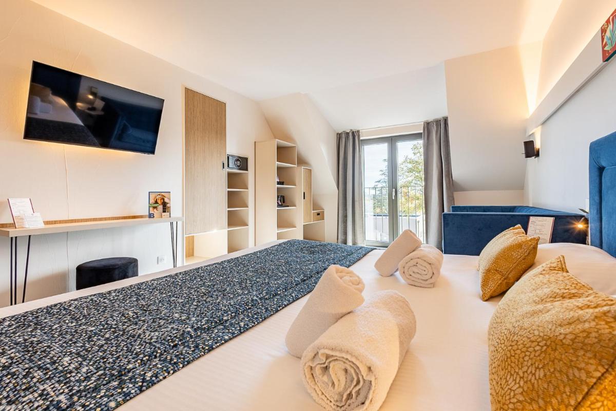 Un ou plusieurs lits dans un hébergement de l'établissement Brit Hotel, Spa & Restaurant - Colmar Est