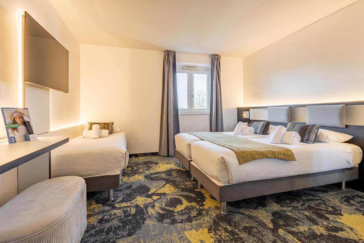 Un ou plusieurs lits dans un hébergement de l'établissement Brit Hotel, Spa & Restaurant - Colmar Est