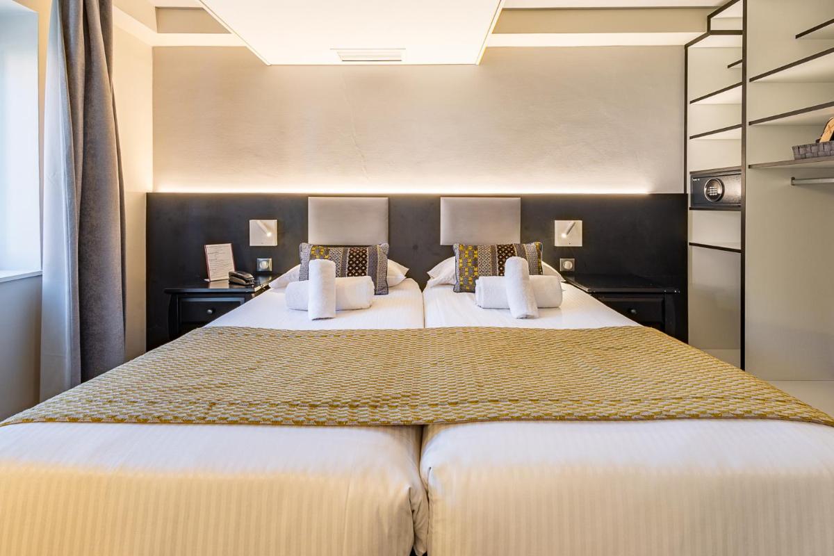 Un ou plusieurs lits dans un hébergement de l'établissement Brit Hotel, Spa & Restaurant - Colmar Est