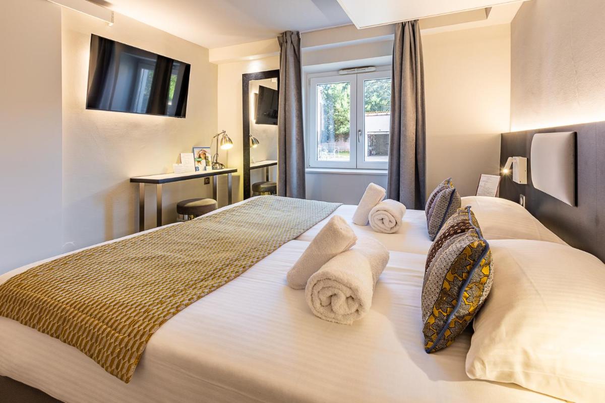 Un ou plusieurs lits dans un hébergement de l'établissement Brit Hotel, Spa & Restaurant - Colmar Est