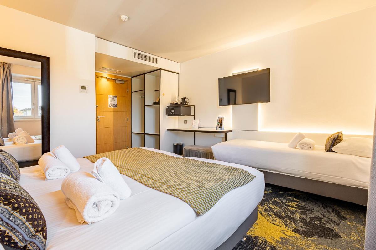 Un ou plusieurs lits dans un hébergement de l'établissement Brit Hotel, Spa & Restaurant - Colmar Est
