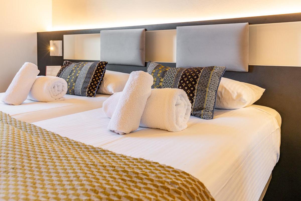 Un ou plusieurs lits dans un hébergement de l'établissement Brit Hotel, Spa & Restaurant - Colmar Est