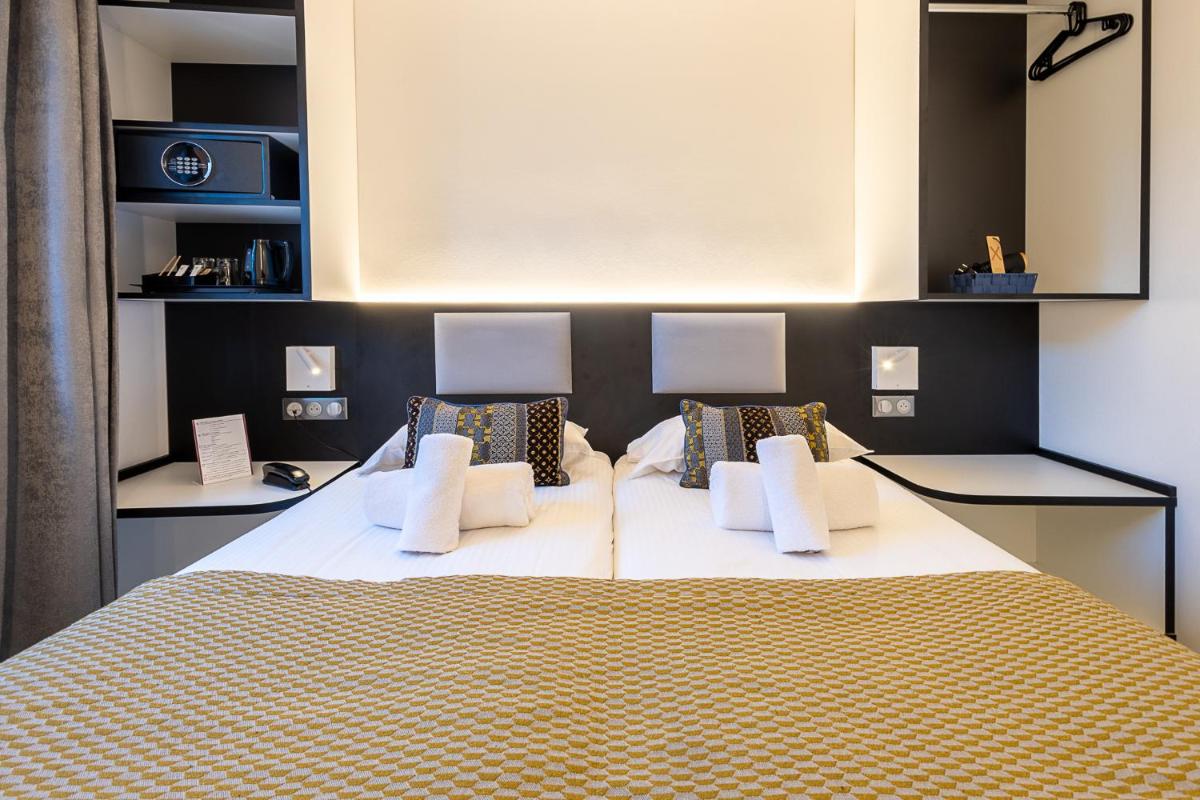 Un ou plusieurs lits dans un hébergement de l'établissement Brit Hotel, Spa & Restaurant - Colmar Est