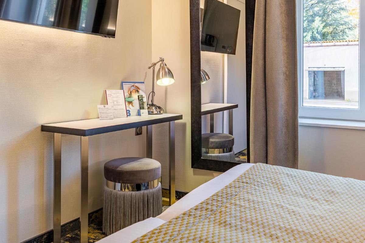 Un ou plusieurs lits dans un hébergement de l'établissement Brit Hotel, Spa & Restaurant - Colmar Est