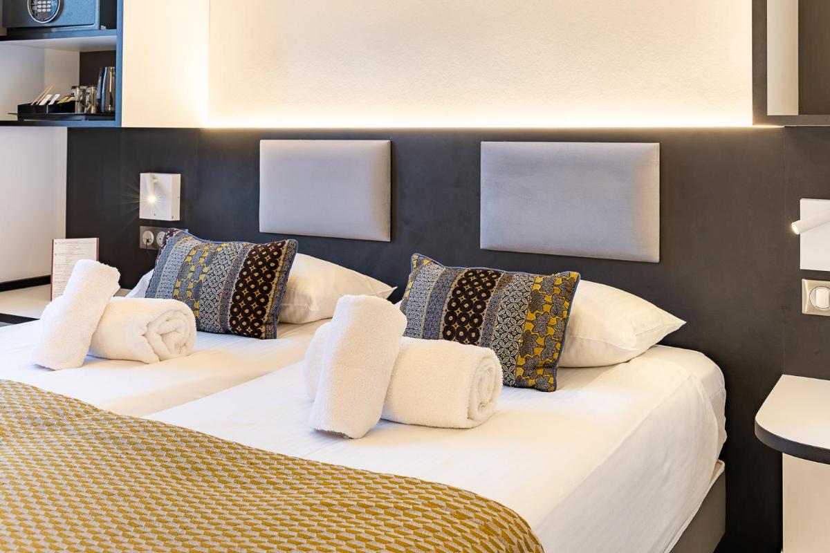 Un ou plusieurs lits dans un hébergement de l'établissement Brit Hotel, Spa & Restaurant - Colmar Est