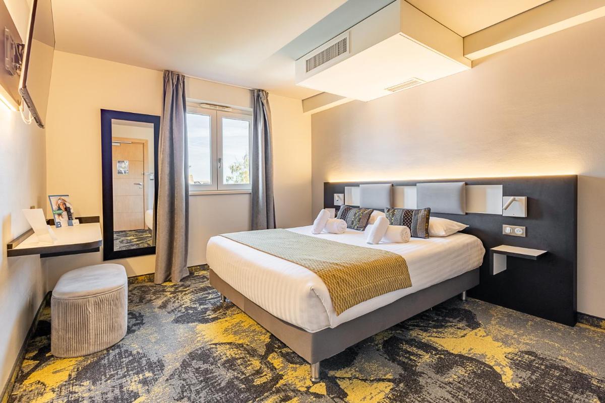 Un ou plusieurs lits dans un hébergement de l'établissement Brit Hotel, Spa & Restaurant - Colmar Est