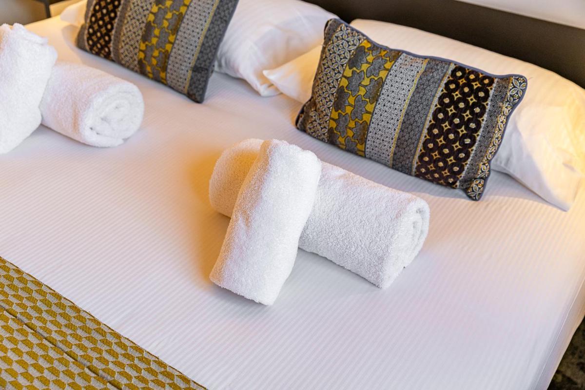 Un ou plusieurs lits dans un hébergement de l'établissement Brit Hotel, Spa & Restaurant - Colmar Est