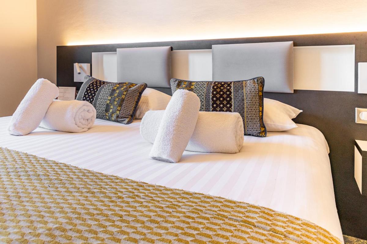 Un ou plusieurs lits dans un hébergement de l'établissement Brit Hotel, Spa & Restaurant - Colmar Est