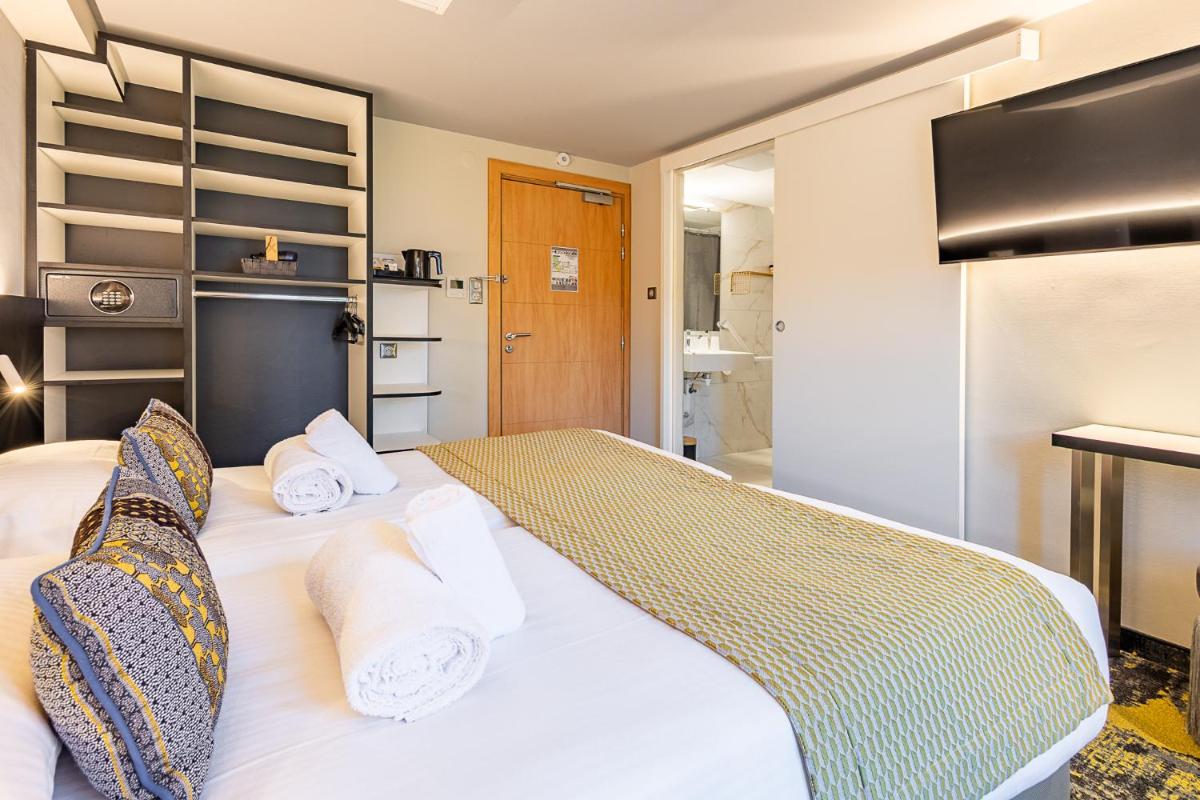 Un ou plusieurs lits dans un hébergement de l'établissement Brit Hotel, Spa & Restaurant - Colmar Est